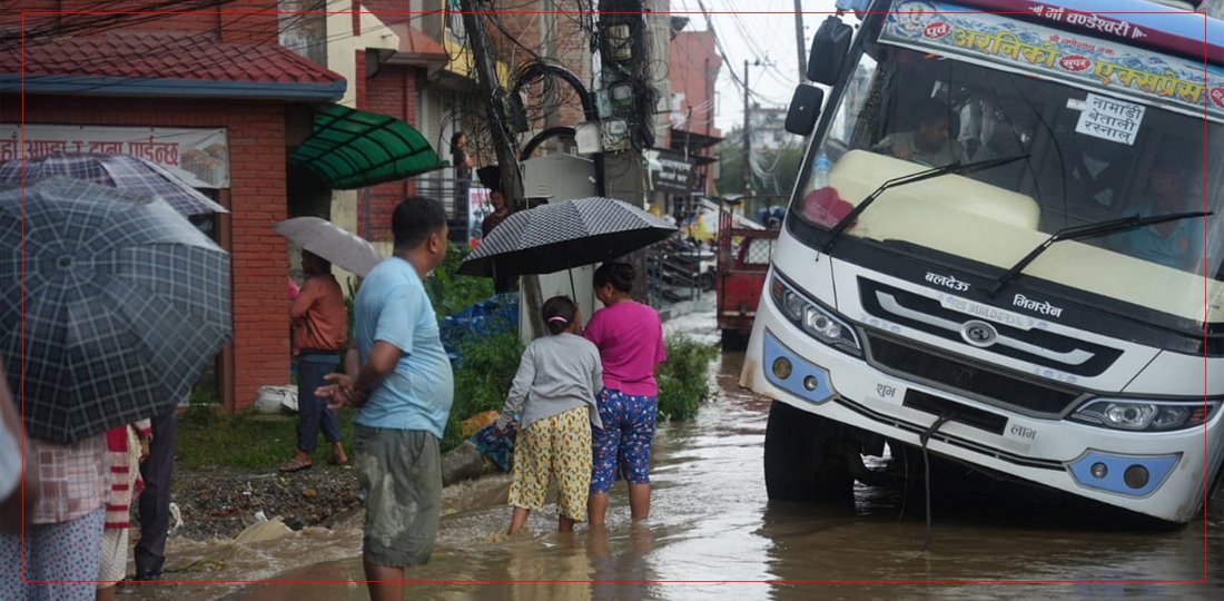 भारी वर्षाका कारण यात्रुबाहक बस नालीमा फस्याे, तस्बिरहरू